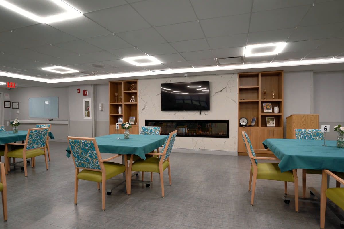 Bright dining room with tables set for residents