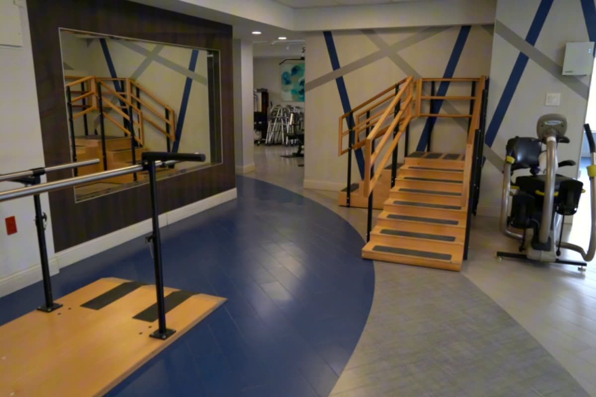 Rehab gym with parallel bars and practice stairs